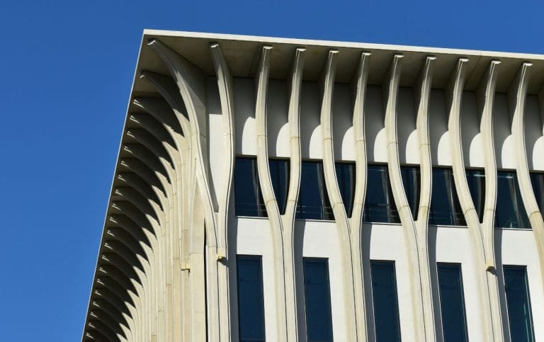 Amare building, known for its distinctive white columns shaped like tuning forks